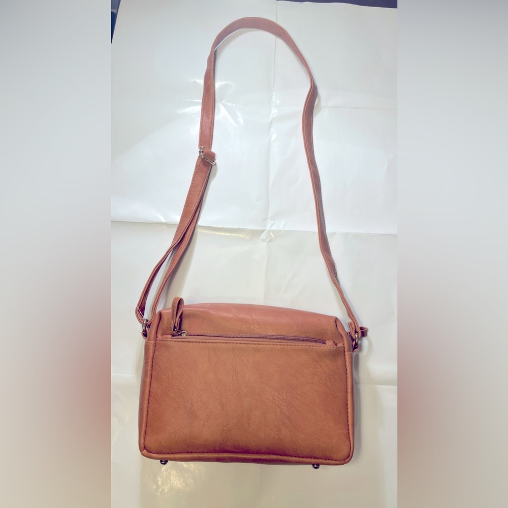 Brand new light brown vegan leather women’s hand bag.